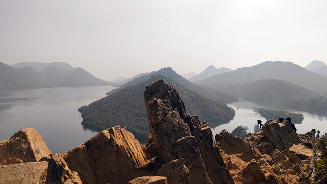 Panoramic view of rocky hills and lake from Bahubali Hills in Udaipur