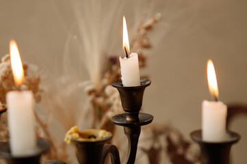 Three candles are lit on a candlestick