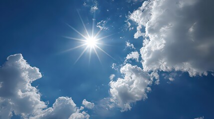 Bright Sun Shining Through Fluffy Clouds on a Clear Blue Sky Background