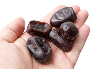 Dried dates in hand isolated on white background. Close-up