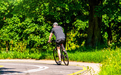 Naklejka premium Cyclist ride on the bike path in the city Park 