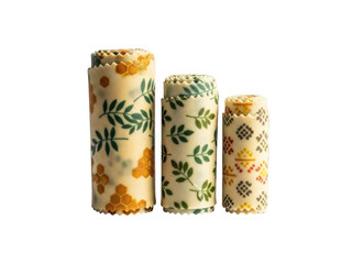 Three rolled beeswax food wraps with different patterns isolated on transparent background