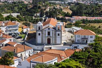 The historic Church of Saint Peter (Igreja de S&atilde;o Pedro) in Palmela, Portugal. A white baroque facade with twin bell towers, seen from a high angle.