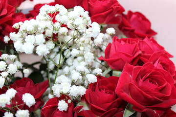 Red roses and white flowers create a stunning bouquet for special occasions or celebrations