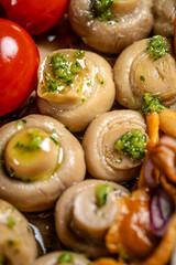 Pickled champignon mushrooms with herbs closeup