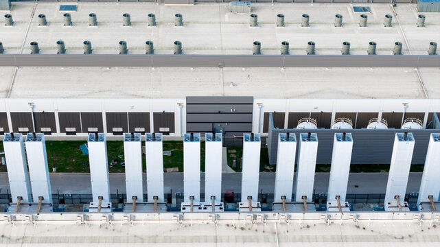 The rooftop infrastructure of a large data center, with numerous ventilation, chiller and cooling systems.