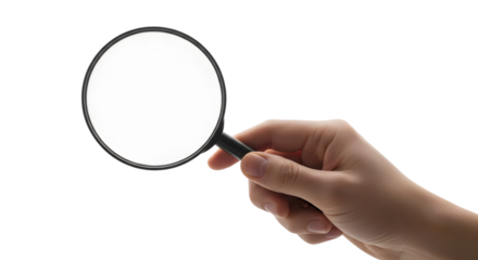 Hand holding a magnifying glass against a black background for investigation
