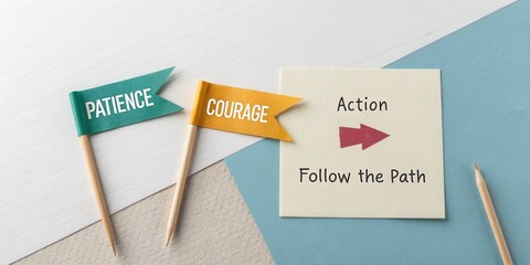 Colorful flags symbolizing patience and courage with action note on desk, inspiring motivation and personal growth concepts