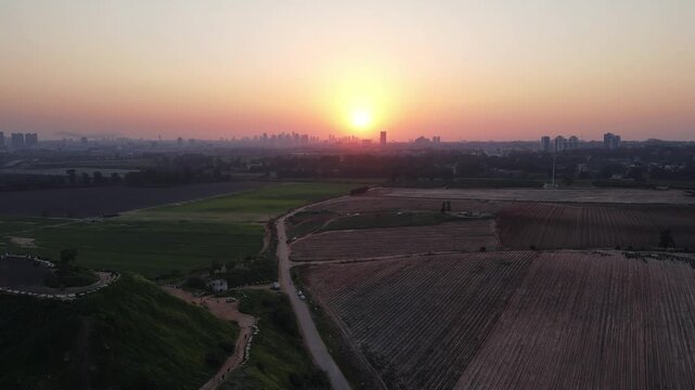 A cinematic view of Hod HaSharon&rsquo;s diverse landscapes, featuring the city&rsquo;s ecological park, surrounding fields, and urban scenery. The footage highlights a peaceful lake, natural greenery, open agric