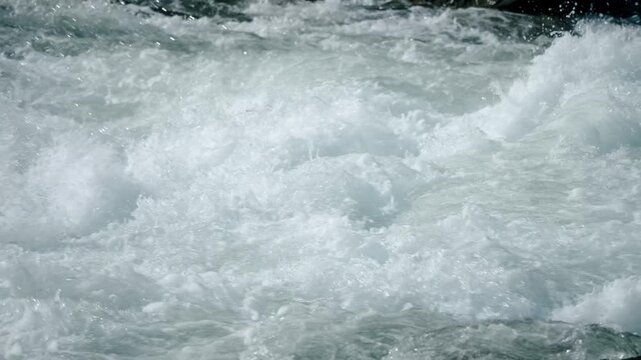 The turbulent waves are breathtaking, characterized by dynamic patterns and foam bubbles in rivers or oceans that truly showcase incredible energy and unparalleled beauty