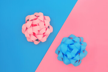 Baby pink blue looped bows on diagonal background. Gift bows for birthday, or baby shower, birth presents. Decorative contrast art abstract design.  