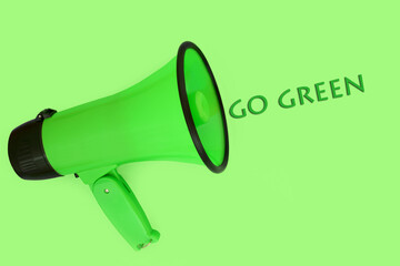 Go green slogan with megaphone loudhailer on green background. Environmental conservation, save and protect nature and the planet concept.