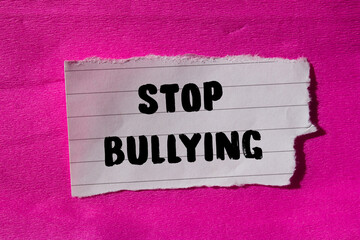 Stop bullying message written on ripped torn paper background. Conceptual Stop bullying symbol. Copy space.