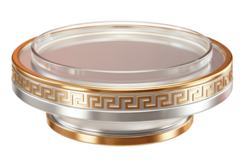 A round display pedestal with a transparent top and metallic base features gold-silver tones and a Greek key pattern.