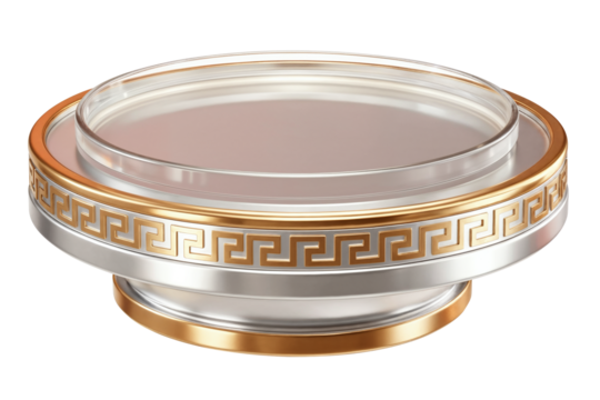 A round display pedestal with a transparent top and metallic base features gold-silver tones and a Greek key pattern.
