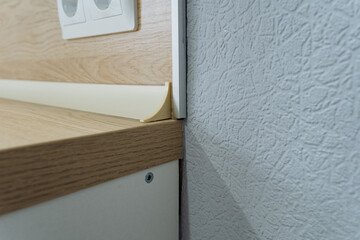 countertop wall assessment, evaluation of countertop and wall joint, closeup of surface joint and finish review, detailed examination of countertop edge meeting wall and outlet