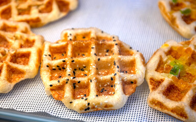 Waffle, Golden baked waffles on shelf, Waffle shop close-up, showcasing a crisp and appetizing texture. Perfect for food design, menus, and bakery advertising