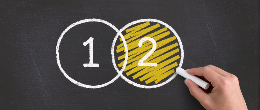 Venn diagram on blackboard, Business man drawing two circles