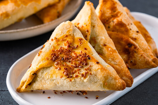 Homemade triangular pastry with spinach and cheese. A traditional Middle Eastern dish.