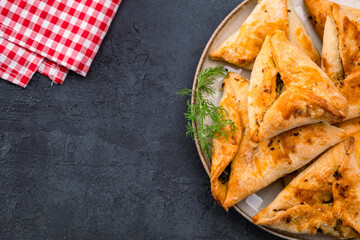 Homemade triangular pastry with spinach and cheese. A traditional Middle Eastern dish.