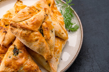 Homemade triangular pastry with spinach and cheese. A traditional Middle Eastern dish.