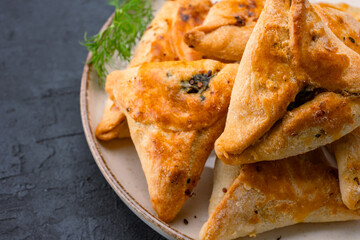 Homemade triangular pastry with spinach and cheese. A traditional Middle Eastern dish.