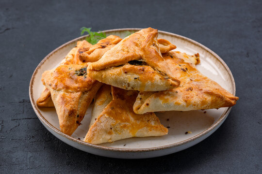 Homemade triangular pastry with spinach and cheese. A traditional Middle Eastern dish.