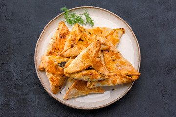 Homemade triangular pastry with spinach and cheese. A traditional Middle Eastern dish.