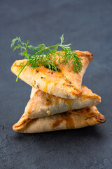 Homemade triangular pastry with spinach and cheese. A traditional Middle Eastern dish.