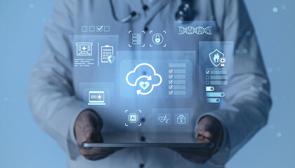 Doctor holding tablet with futuristic medical interface and cloud computing concept icons on digital blue background for healthcare data management.