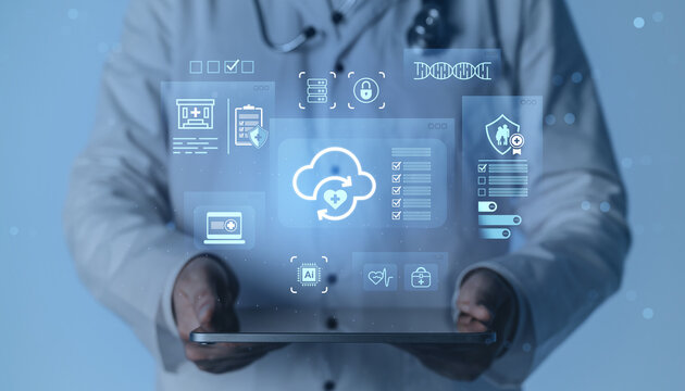 Doctor holding tablet with futuristic medical interface and cloud computing concept icons on digital blue background for healthcare data management. - Powered by Adobe