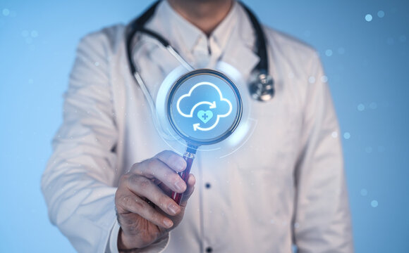 Doctor holding magnifying glass with cloud healthcare icon on digital screen for medical data concept on blue background. - Powered by Adobe