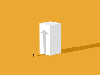 Businessman standing looking at growth arrow shadow