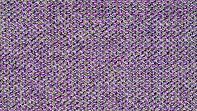 Close-up photo of fabric texture for use as background. The fabric is made from a mixture of purple, gray, and pale orange threads. A mixture of synthetics and wool. Abstract pattern.