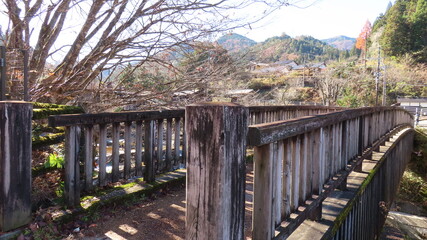 Traditional wooden bridge in rural Japanese village landscape