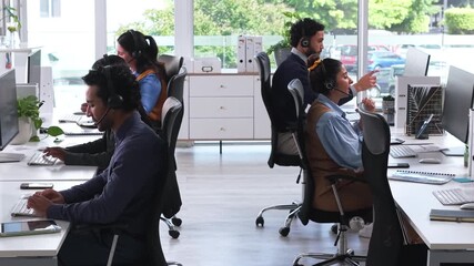 Call center, discussion and people with headset, coworking and help with troubleshooting on website. IT team, computer and group with mic for tech support, contact us and communication in office - Powered by Adobe