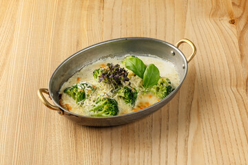 Bowl of fresh vegetable soup with vegetables. Broccoli Cheddar Soup.