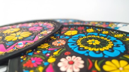 Close-up of black surfaces adorned with colorful floral patterns, showcasing vibrant details