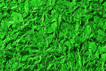 Shiny metal green foil leaf crumpled texture background.