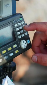 Surveyor using electronic theodolite total station device. Clip