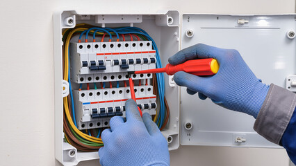 electrician fixing main fuse box 