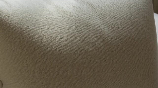 Beige cushion detail shot for relaxing home interior style, perfect for cozy living room design or neutral bedroom decor projects