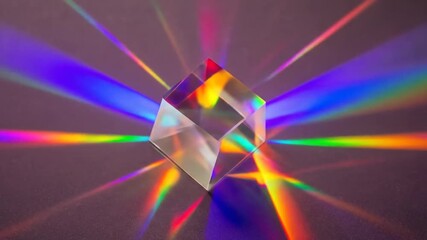 A clear prism refracts light, creating a rainbow spectrum on a dark surface, showcasing dispersion - Powered by Adobe