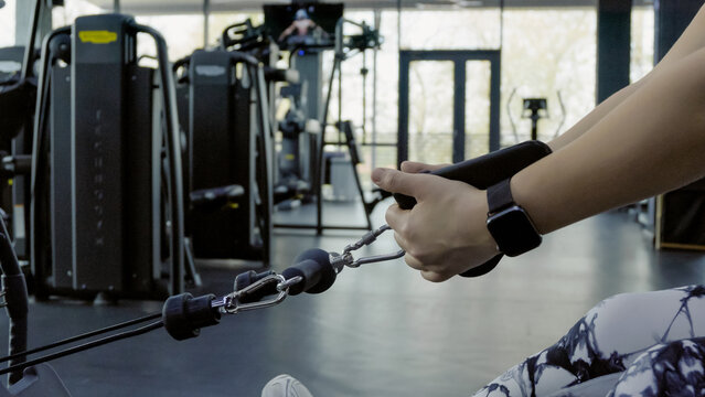 Person lifting a barbell in a gym