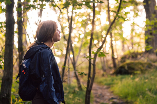 Female backpacker exploring forest during hike travel