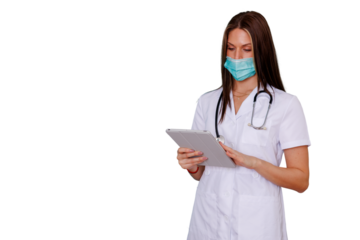 Female doctor or medical professional using a digital tablet, wearing a face mask and lab coat, transparent background