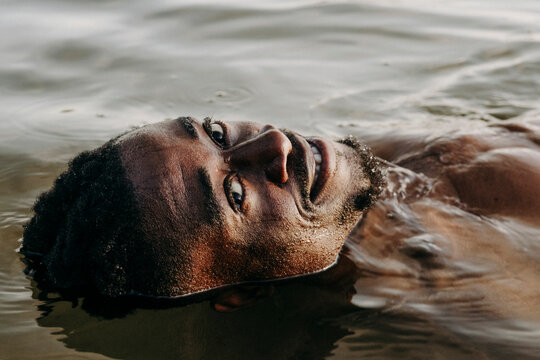 High angle portrait of smiling man in water