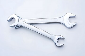 Two Silver Wrenches Crossed on White Background