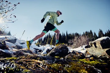 Fototapete Rund Gymnastik Man running trough the river in the winter mountains  © pikoso.kz