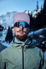 Man bearded runner in the winter mountains